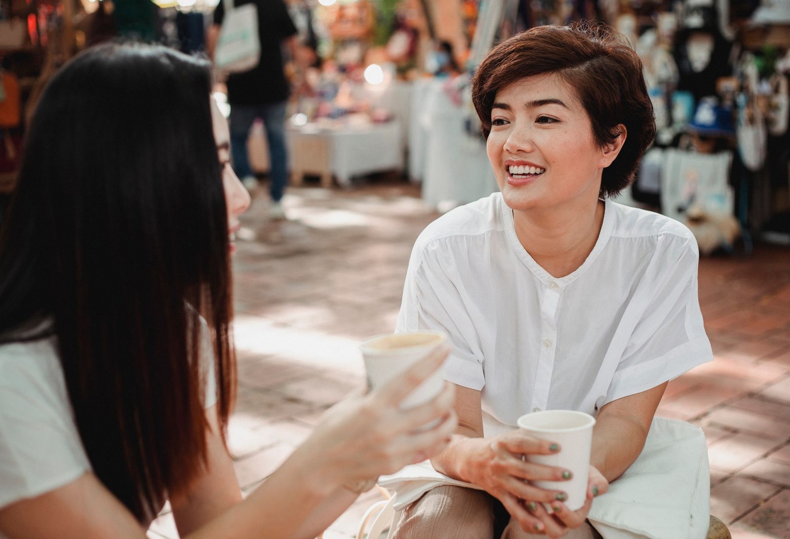 Asian women talking together over coffee