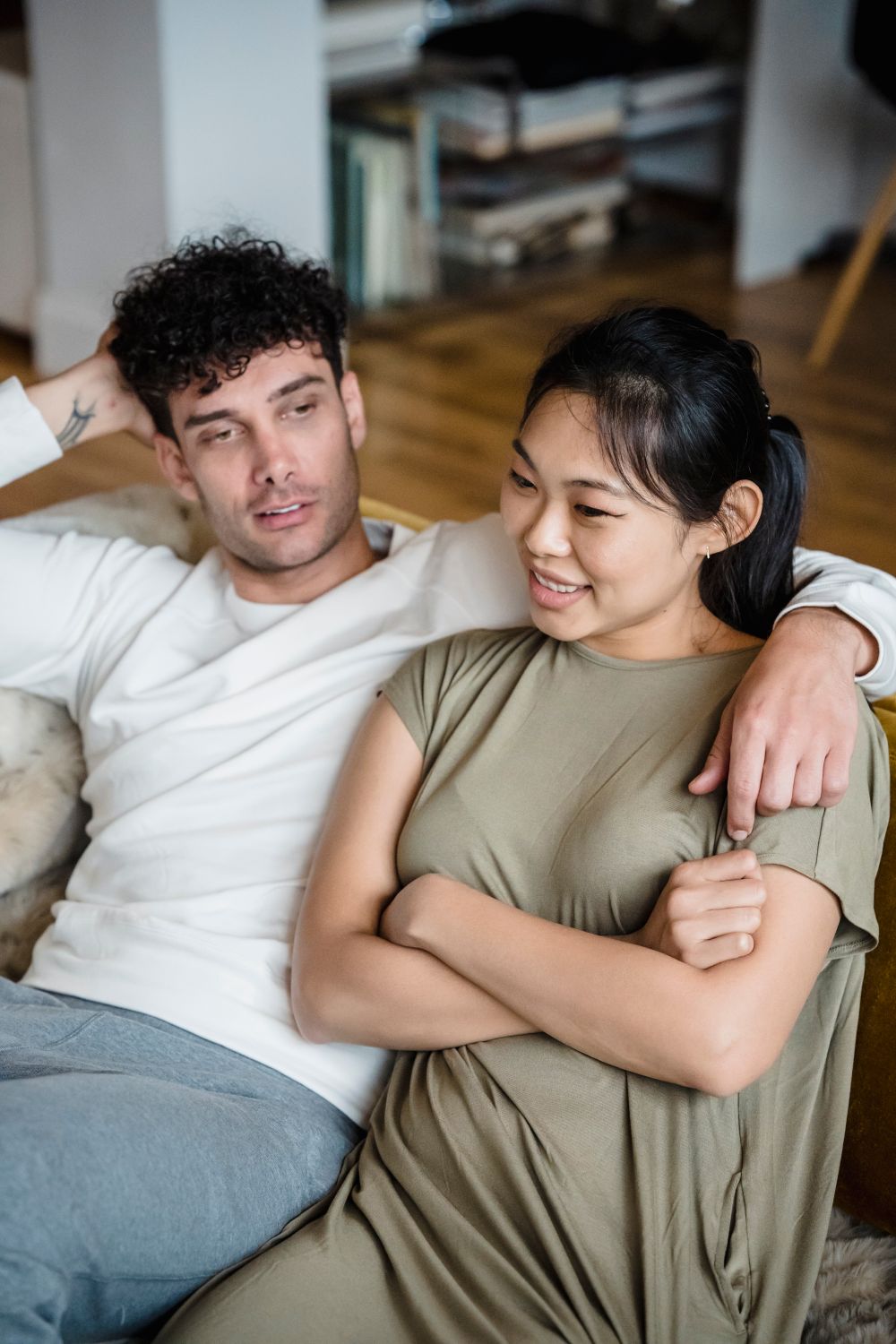 An Asian woman and Caucasian man talking comfortably instead of relying on assumptions
